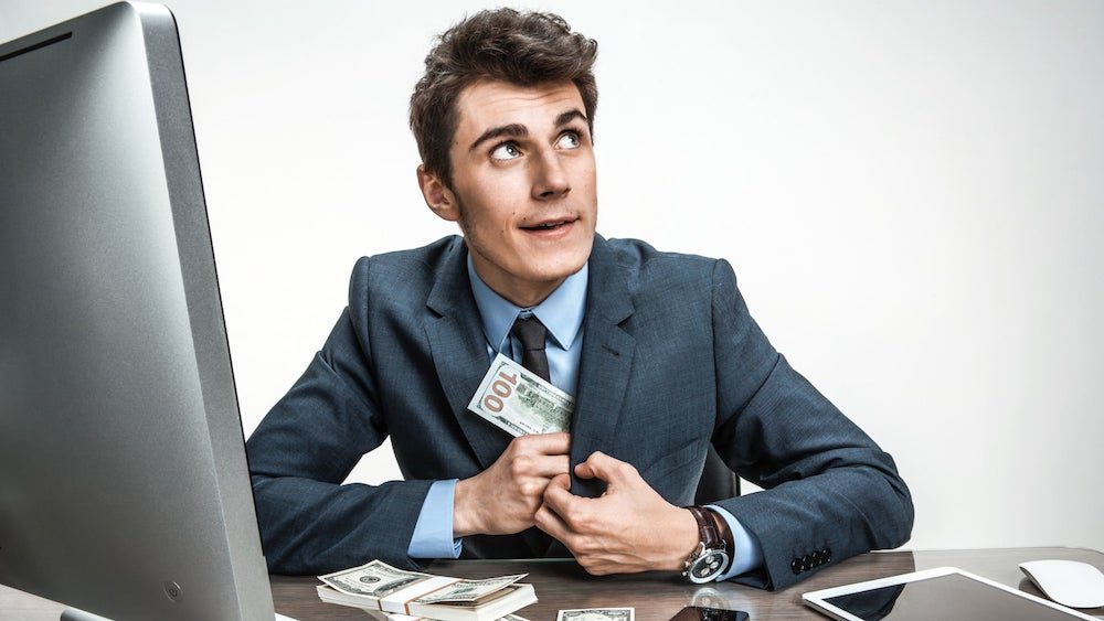 Businessman stuffs hundred-dollar bill in suit jacket | Myth: Lenders Work on Commission | Wise Loan