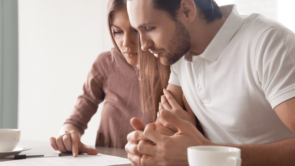 a couple looks over a contract
