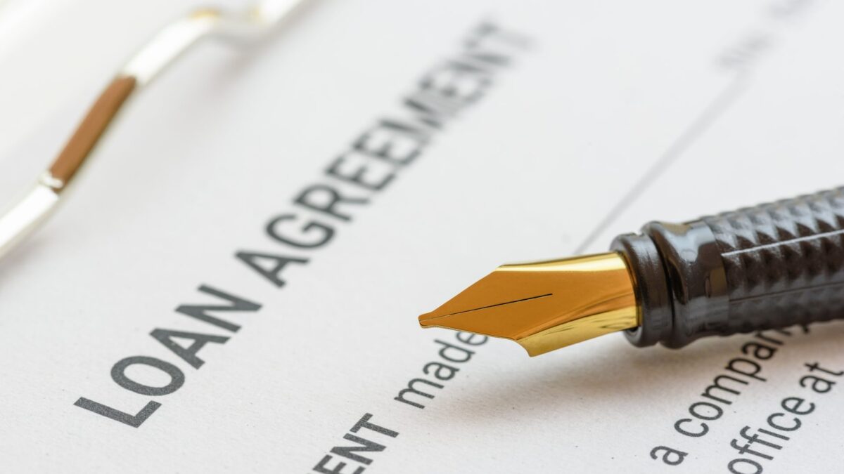 loan agreement paperwork with a pen on top