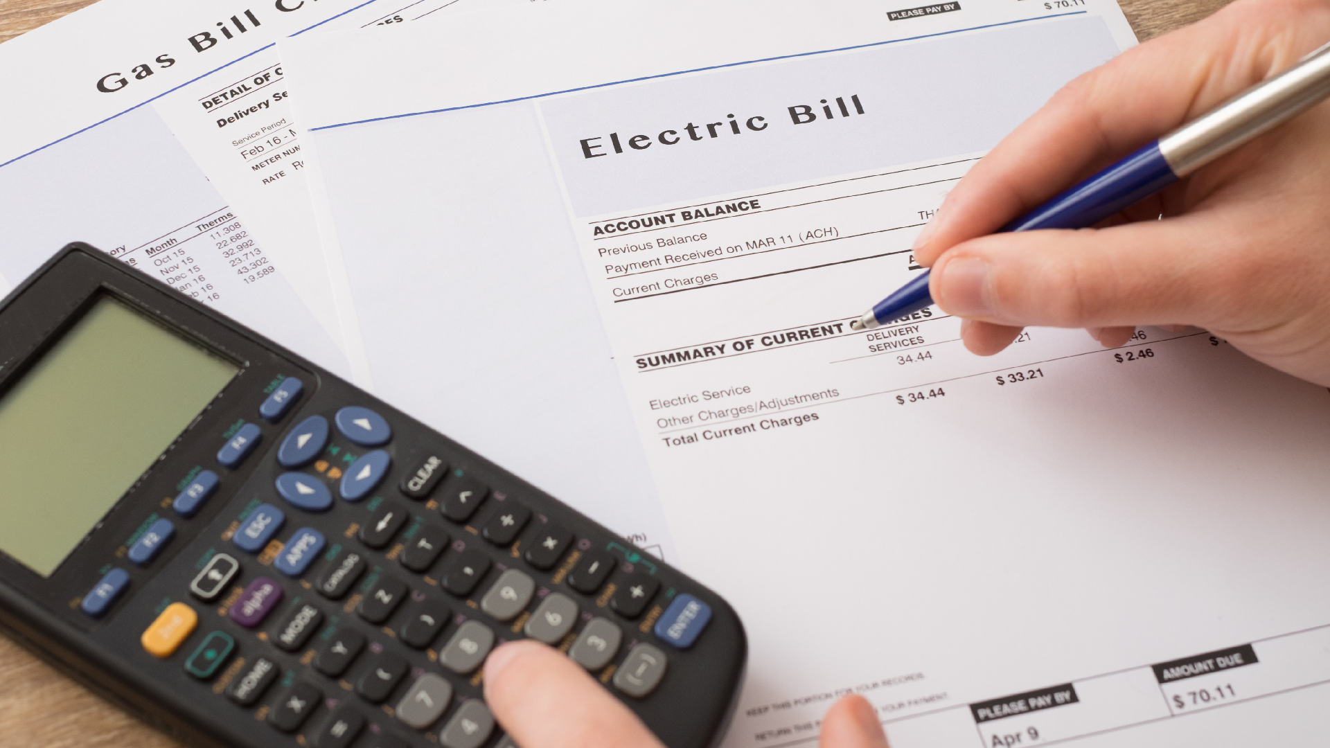 an electric bill with a calculator on top
