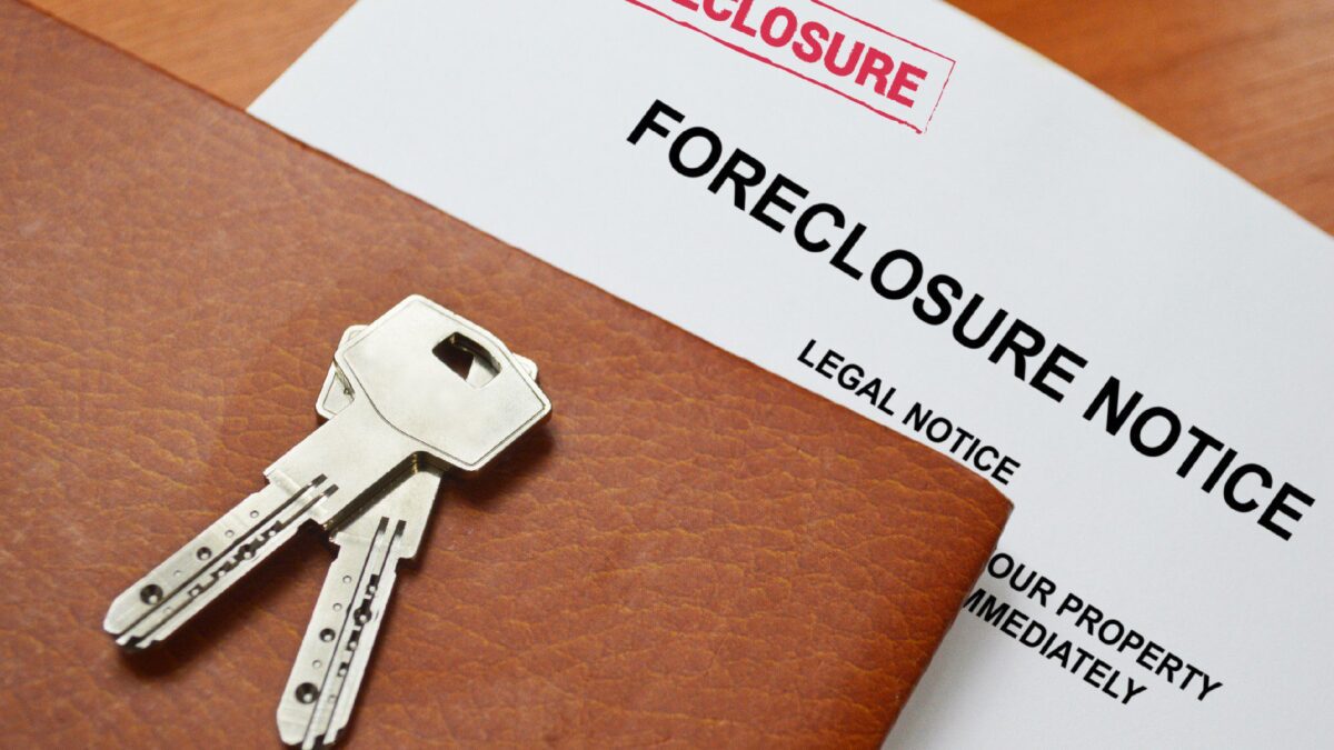 a foreclosure notice sits below keys and a portfolio