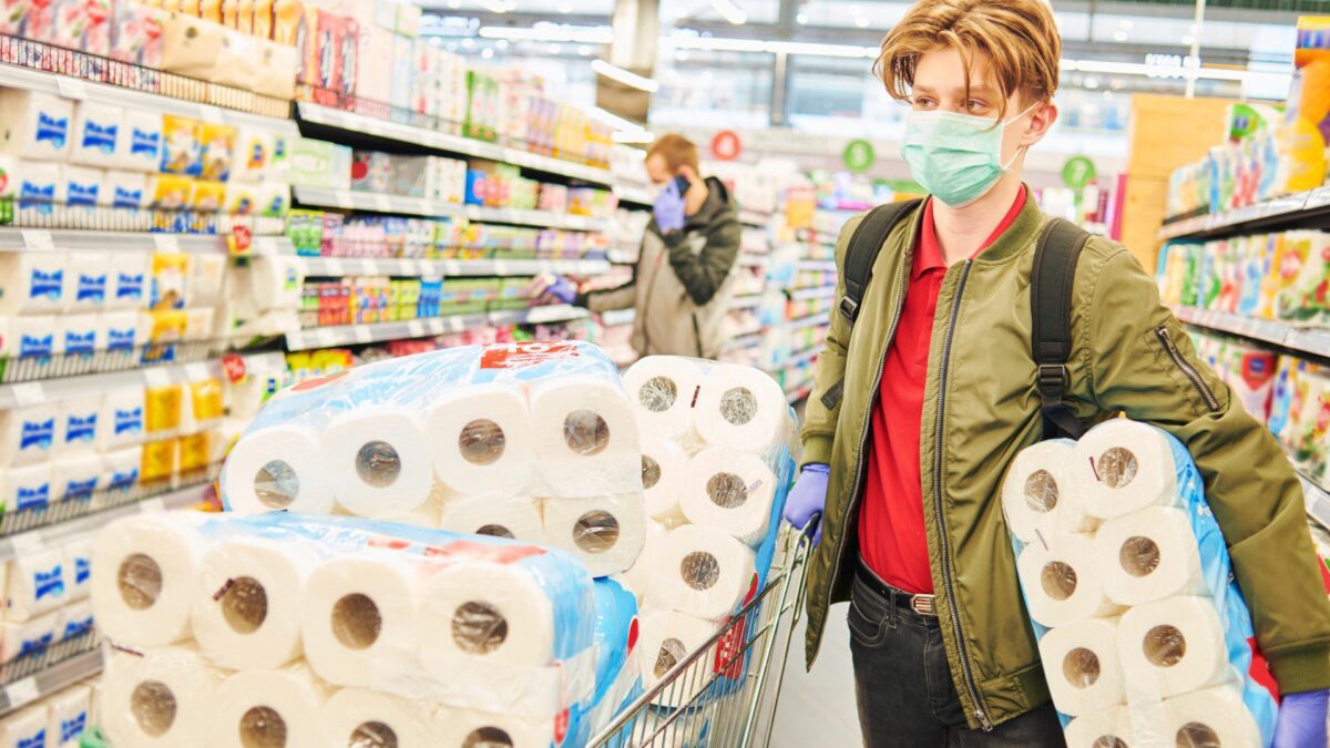 a person-shops for toilet paper and other provisions to prepare for emergencies