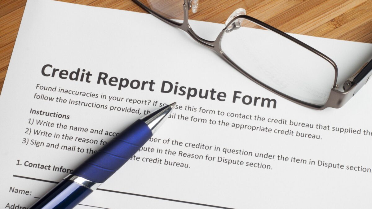 a credit report dispute form — where you dispute errors on your credit report — sits on a desk