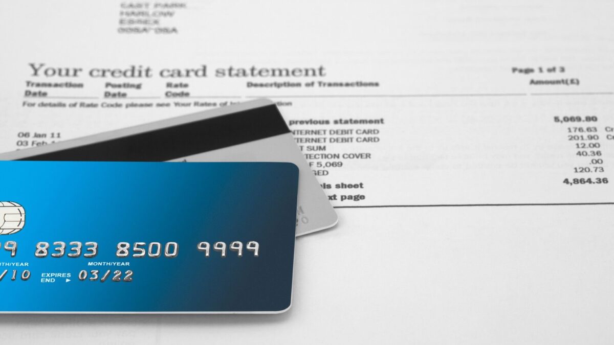 credit cards sit on top of credit card statemen