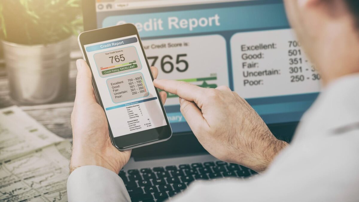 a person holds a mobile phone with an excellent credit score on display