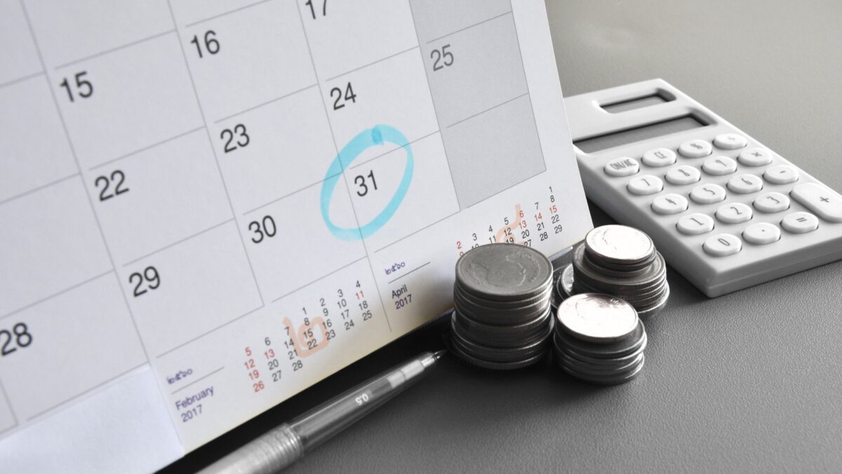 coins sit in front of a calendar
