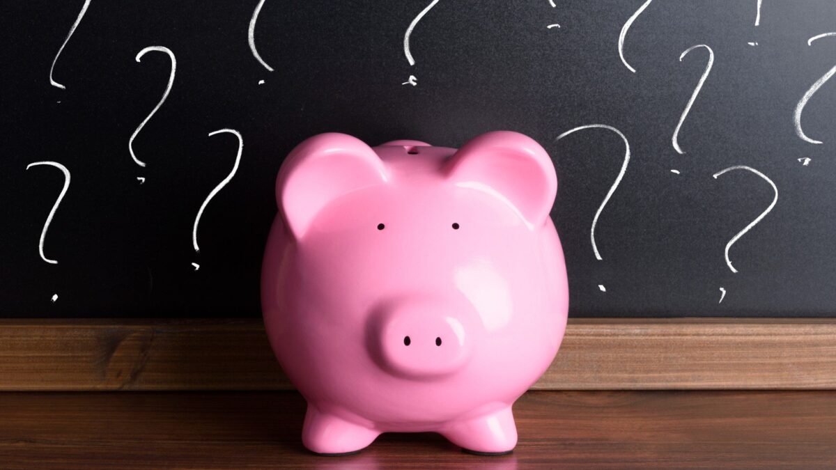 a piggy bank is surrounded by question marks