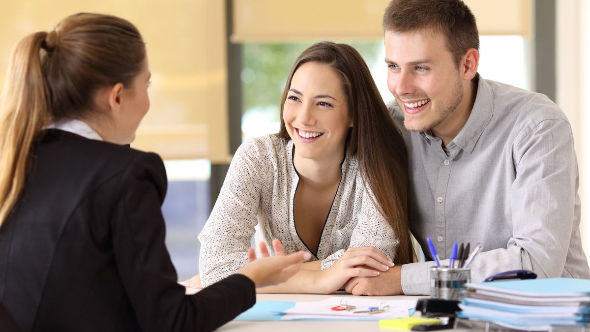 Couple smiling while talking to loan advisor | Credit Inquiries | Wise Loan