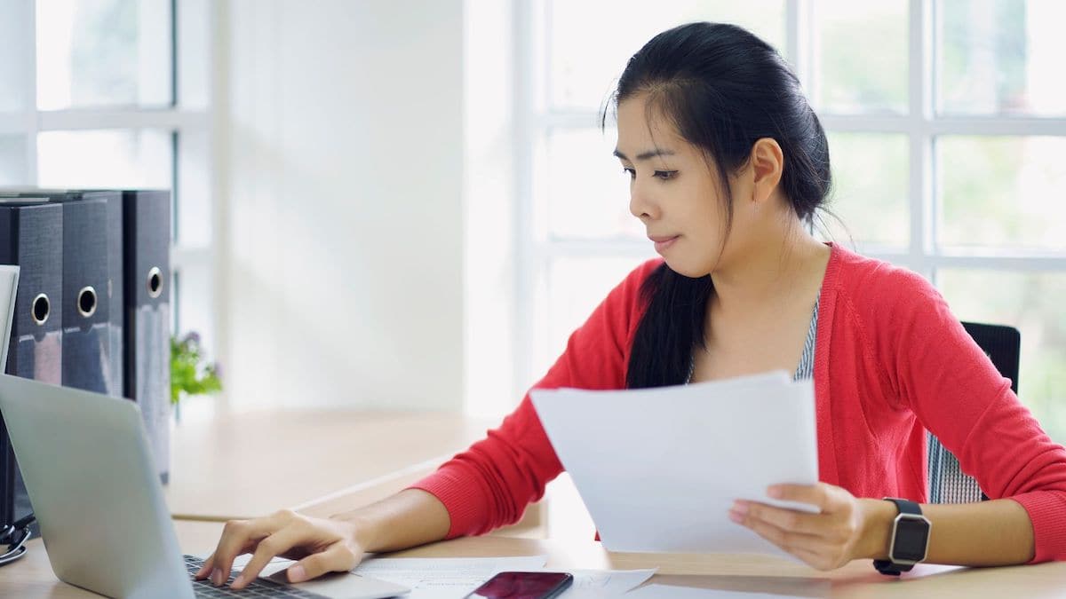 Woman looking at loan terms online using laptop | Wise Loan