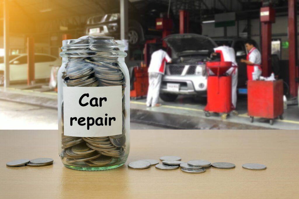 Jar full of quarters sitting on desk in front of mechanic shop | Auto repair financing options