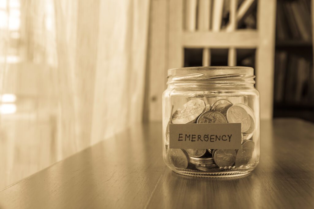 A jar full of coins for an emergency fund | Emergency reasons to borrow money