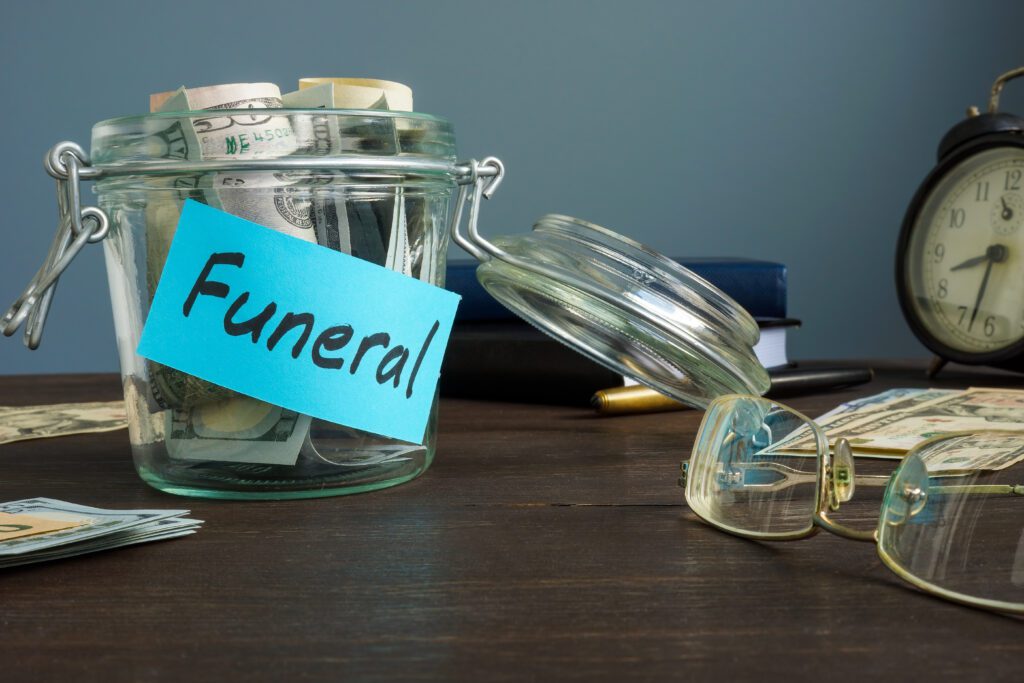 A glass jar of bills for funeral expenses | Emergency reasons to borrow money