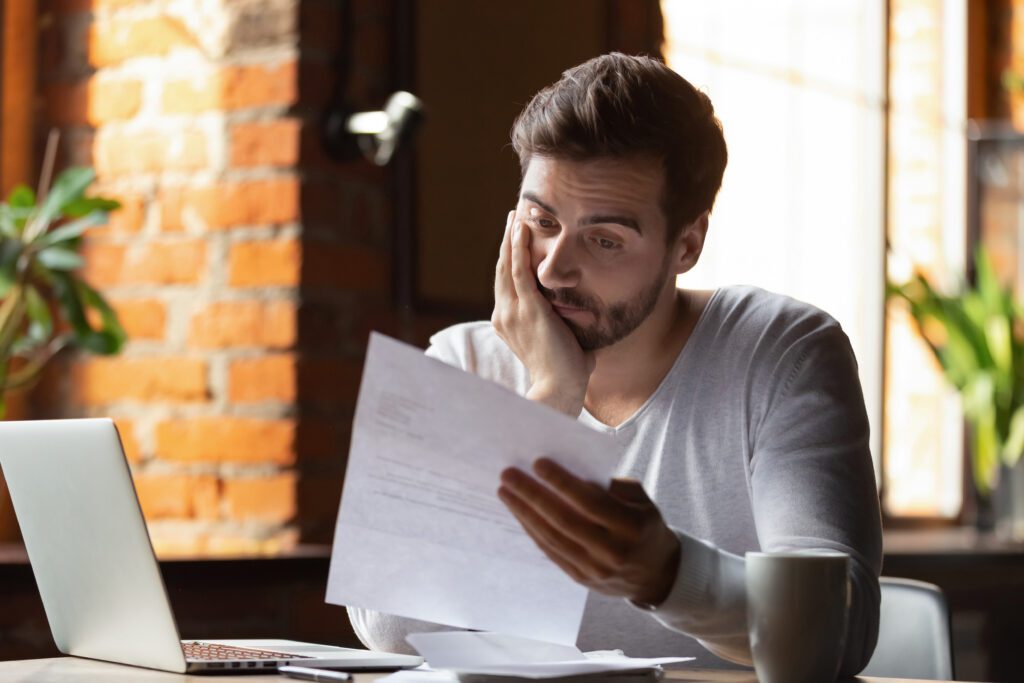 A young man who just received a termination letter | Emergency reasons to borrow money