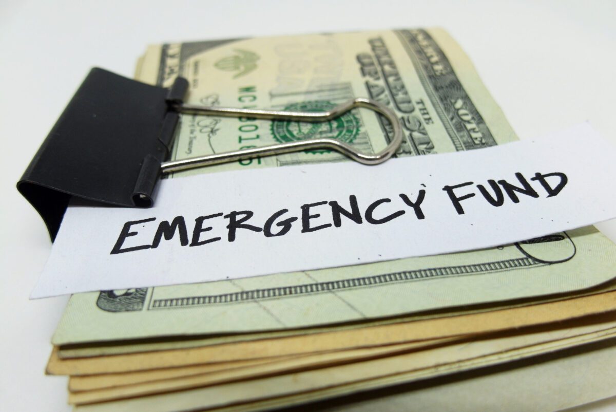 A stack of bills held together with a clip | Emergency reasons to borrow money
