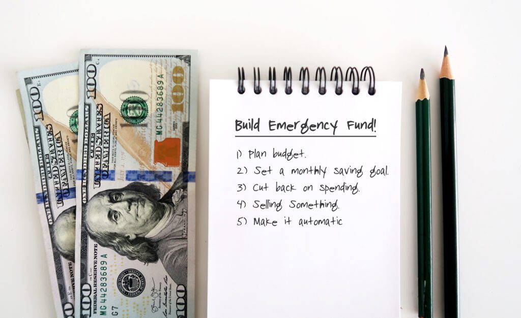 Steps to build an emergency fund written on a notepad | Emergency reasons to borrow money