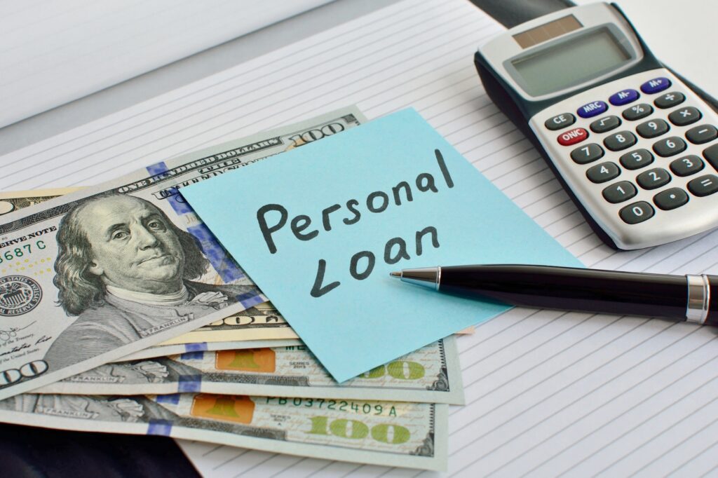 Sticky note labeled as personal loan sticks to three hundred-dollar bills | Funeral financing options