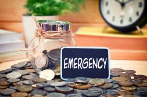 The word, “Emergency” on a mini chalkboard | How do emergency loans work?
