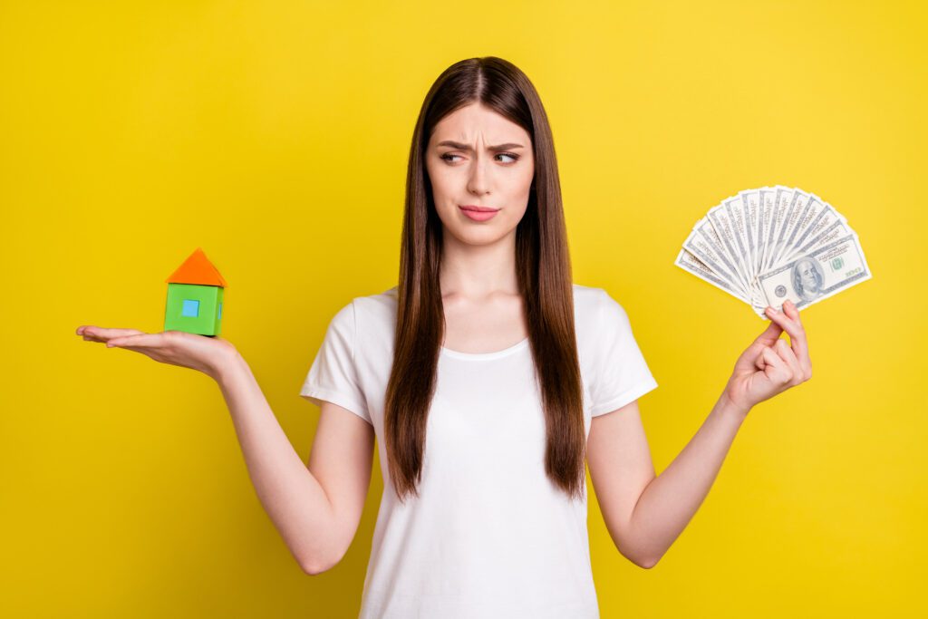 A woman weighing the pros and cons of a loan | How do home repair loans work?