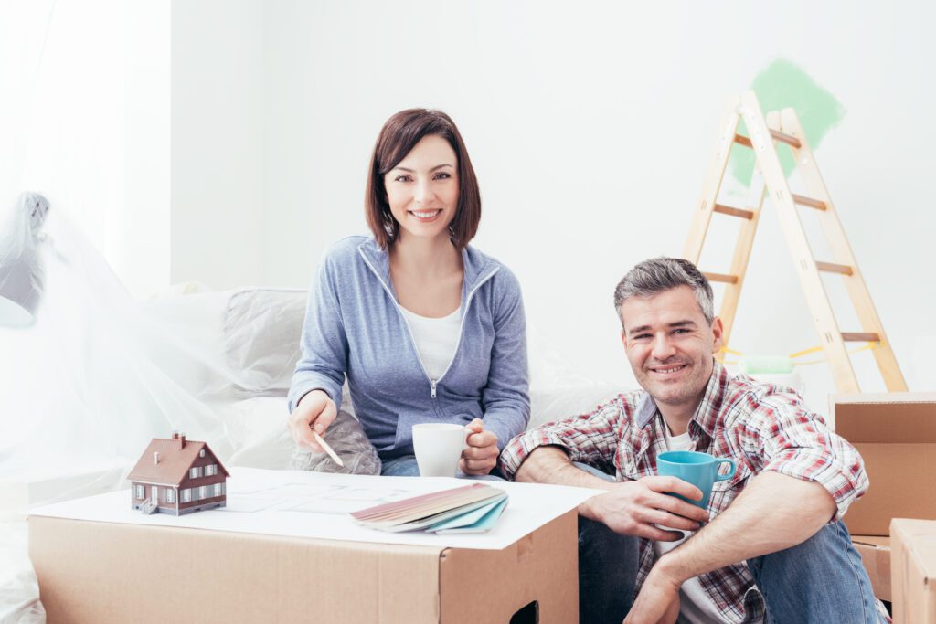 A happy couple making design updates to their home | How do home repair loans work?