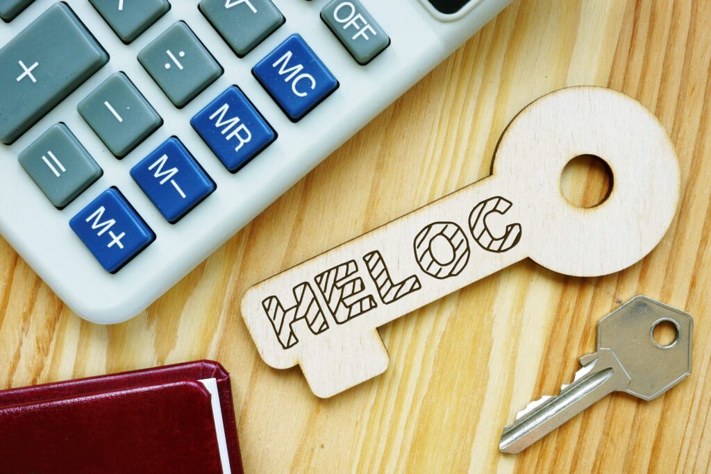 The acronym, “HELOC,” on a wooden key | How do home repair loans work?