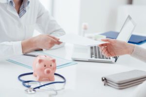 A doctor handing a medical bill to a patient | How do medical loans work?