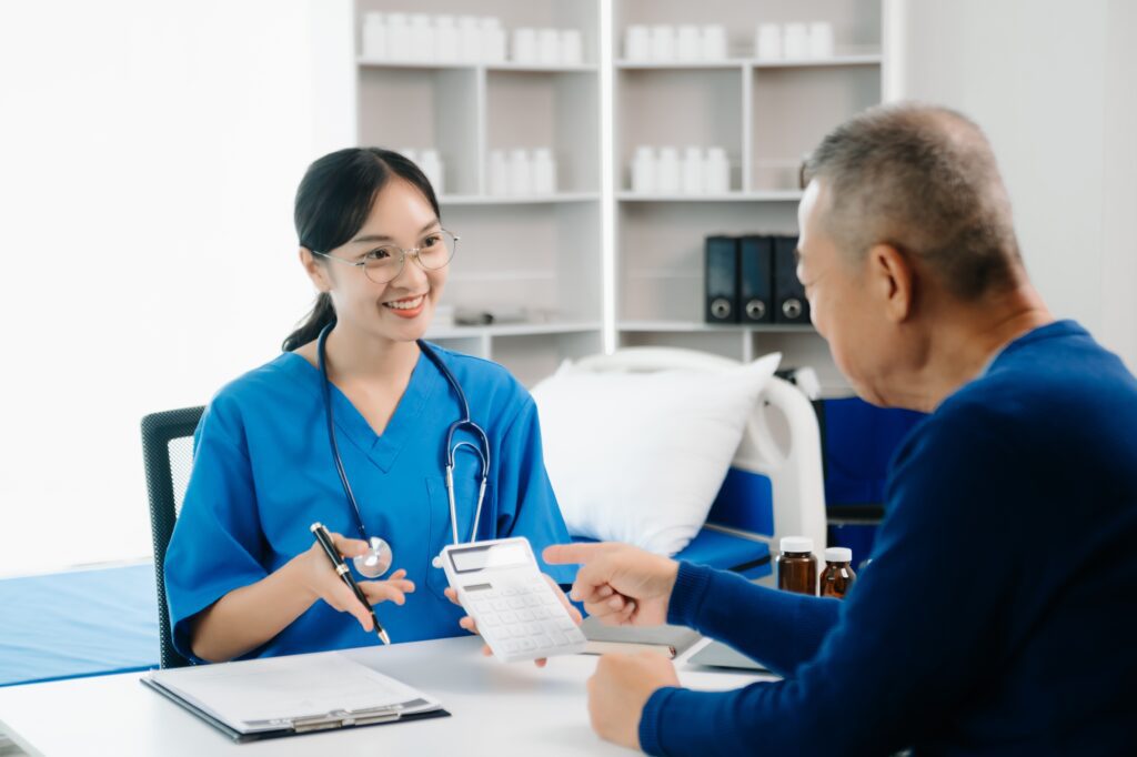 A healthcare professional sorting out a bill with a patient | How do medical loans work?