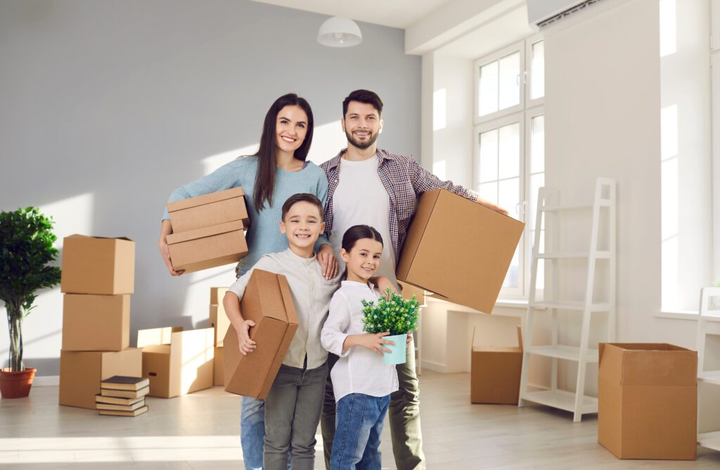 A young happy family moving into their new home | How does a relocation loan work?