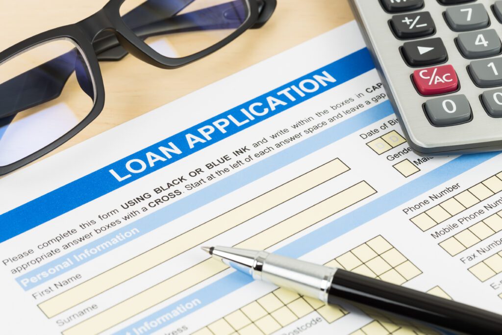 A medical loan application next to a calculator | Wise Loan