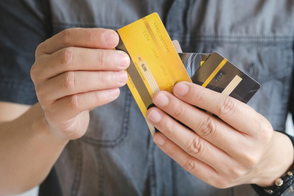 Close up of person fanning a stack of credit cards in his hand | Relocation financing options