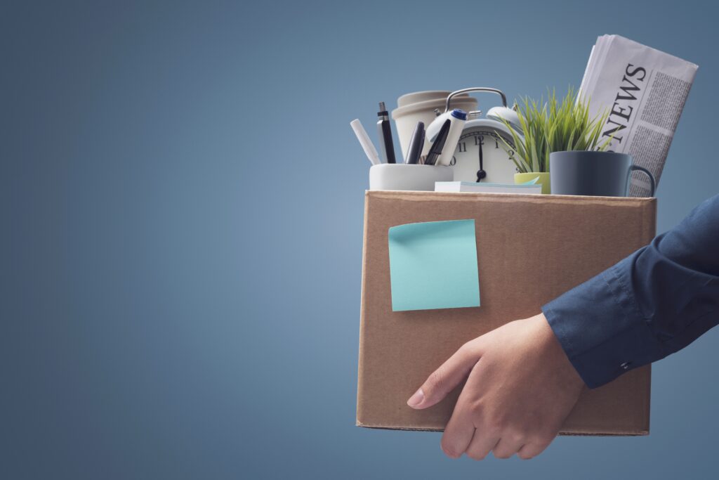 Person holds cardboard box full of personal belongings | Relocation financing options