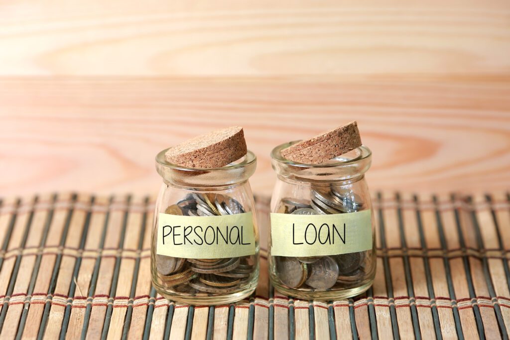 Two small coin jars labeled as personal and loan with cork stoppers | Relocation financing options