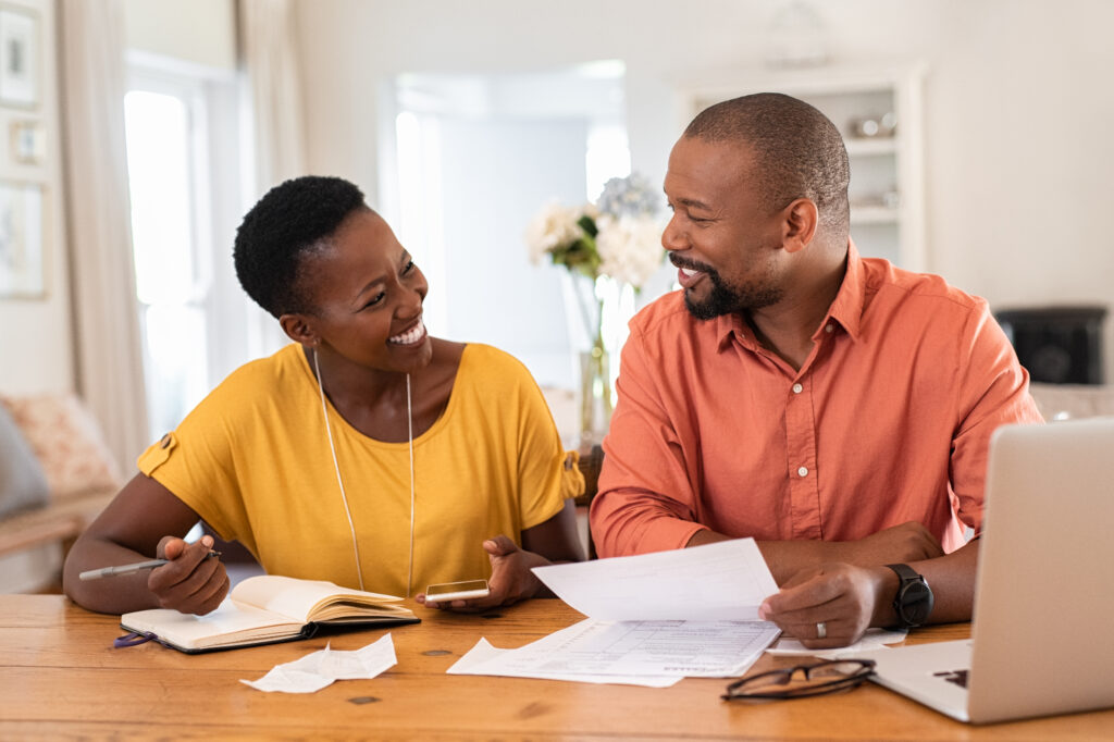 Couple smiles as they make successful plans for financial emergencies | Planning for unexpected expenses