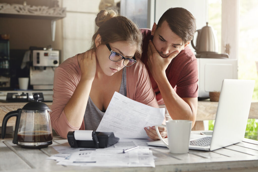 Young couple stressed as they review their emergency expenses | 9 types of emergency loans