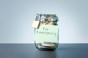 Locked jar full of money labeled as "For Emergencies" | Ways to get emergency money