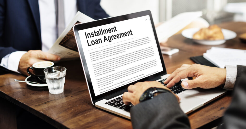 Businessman fills out installment loan application online | Best installment loans