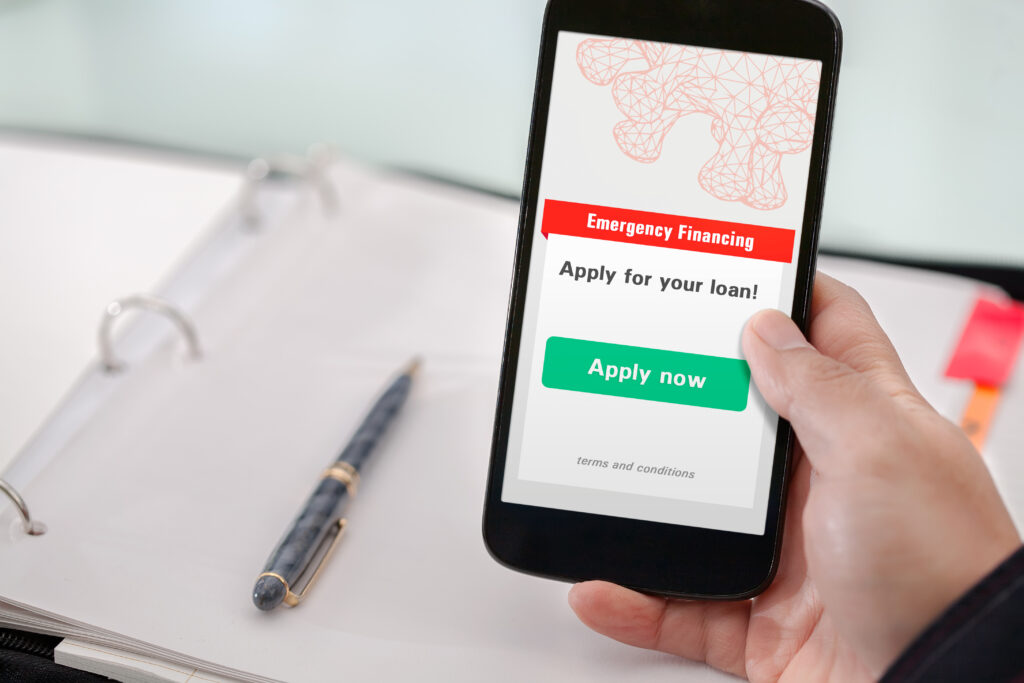 Close up of emergency loan application screen on smartphone | Ways to get emergency money