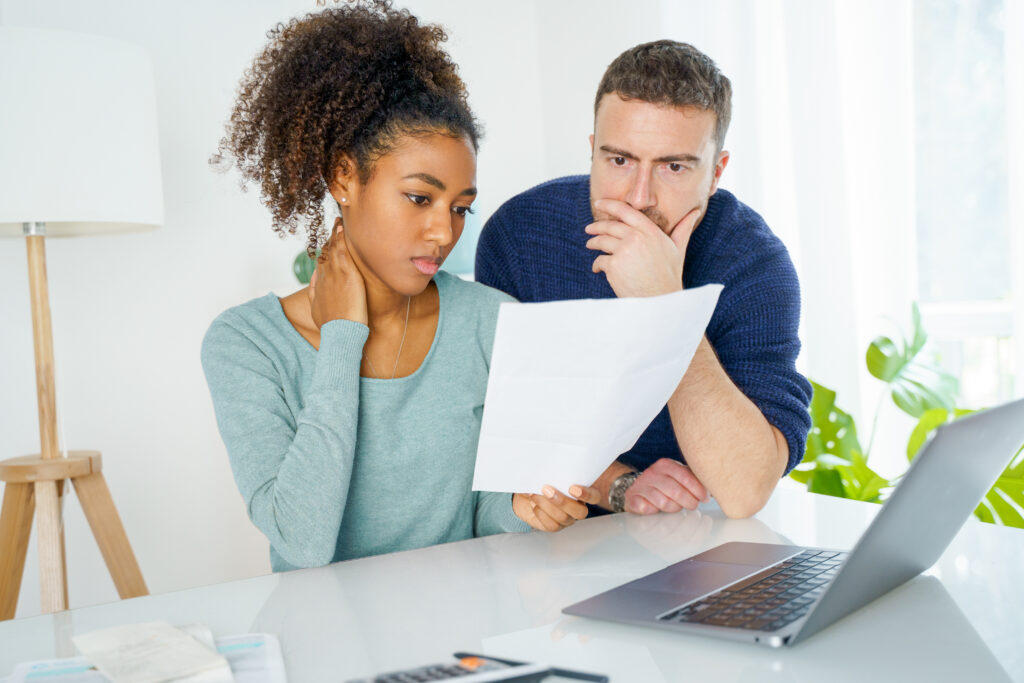 Concerned couple looking at the paper while comparing loan options | Best emergency loans for bad credit