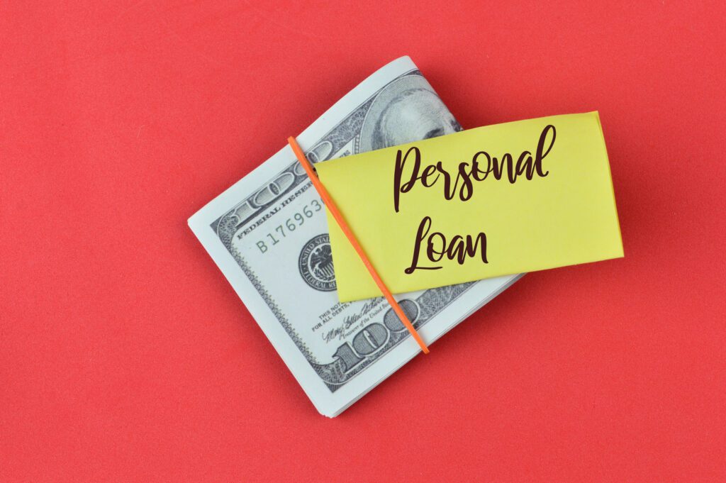 A note that says, “Personal Loan,” on top of bills | Best personal loans