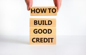 Hand using building blocks | How to build your credit score fast