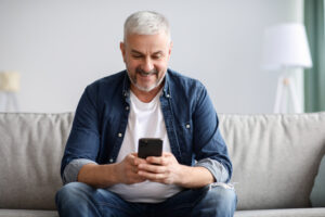 Smiling man using smartphone