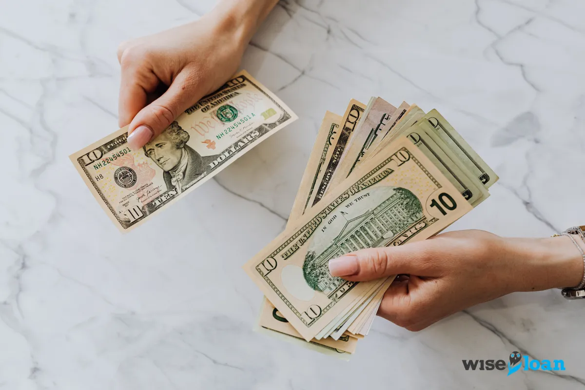 woman holding cash with two hands