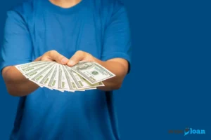 man holding money over blue background